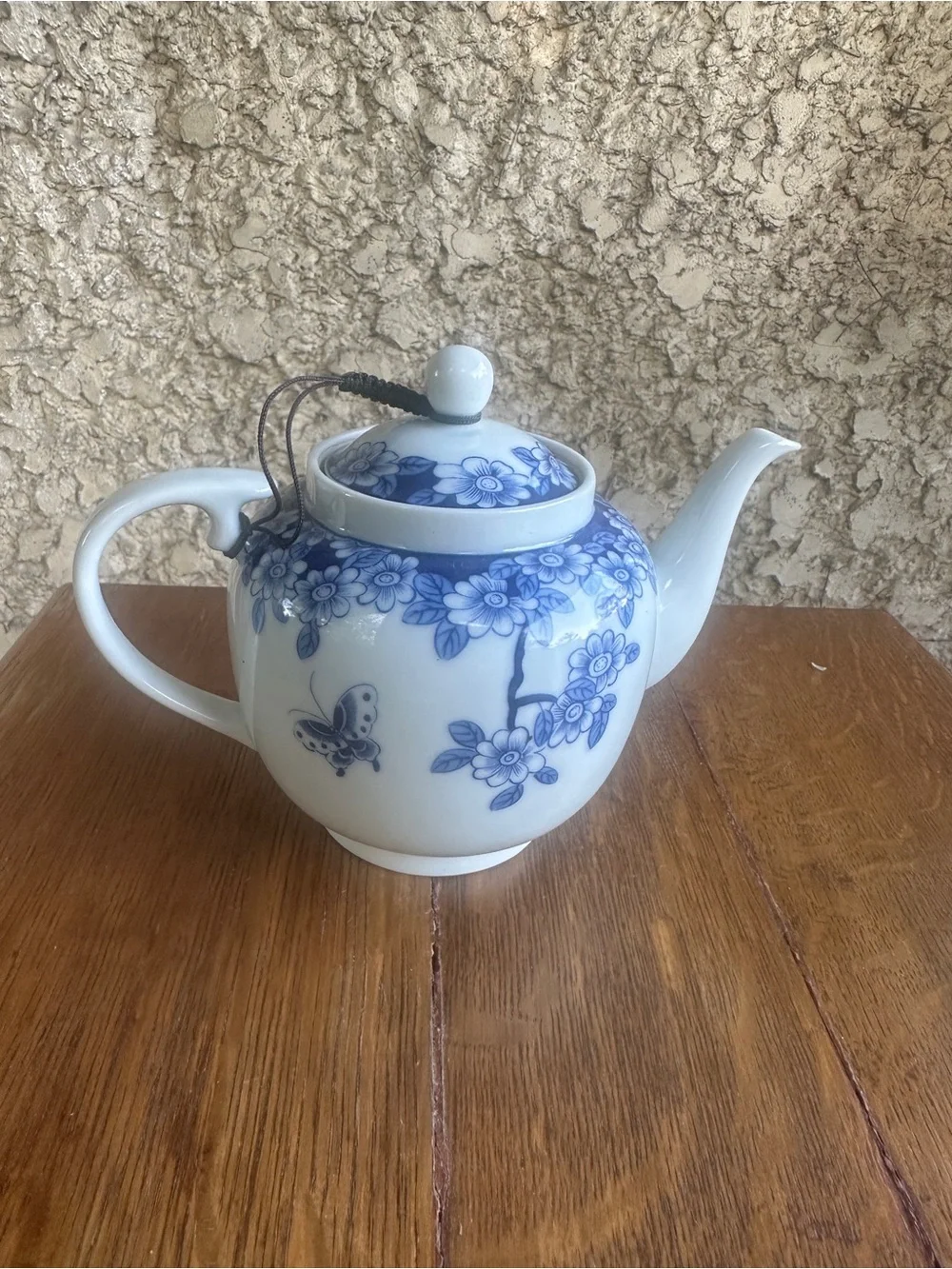 Blue and white floral teapot with butterfly design